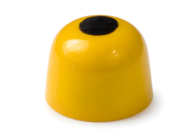 Glossy, vibrant yellow dome-shaped honey and gold chocolates topped with a single dark circle dot